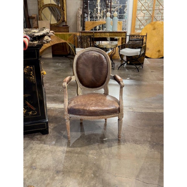 Good 19th century French Louis XVI carved and painted armchair with leather. Circa 1880. A timeless and classic touch for...