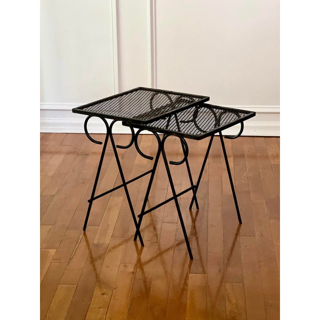 Vintage set of two black wrought iron tables attributed to Maurizio Tempestini for Salterini. Graduated in size, they fit...