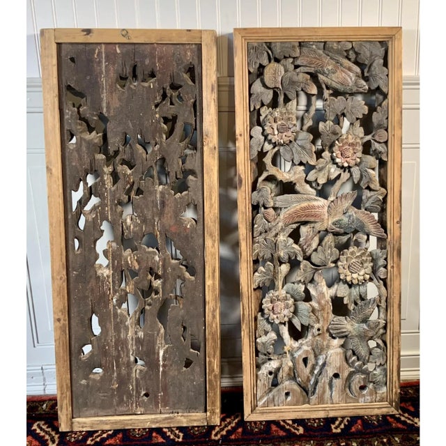 A lovely pair of antique Chinese hanging wood panels with hand-carved avian and floral motifs. Product Information:...
