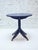 A striking round pedestal side table crafted from wood and finished in a deep navy blue lacquer. It features a unique...