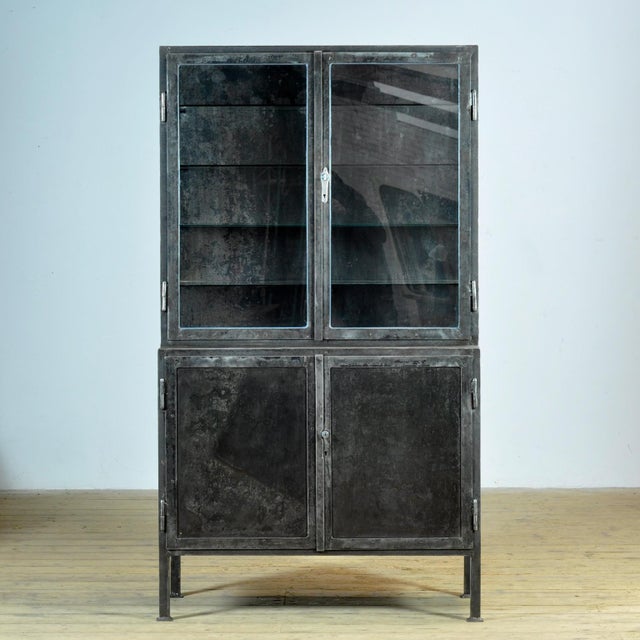 Medical cabinet from the 1930s, made in Hungary. This cabinet is made of iron and glass, creating a robust industrial...