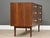 A mid century modern walnut Declaration six drawer dresser with white porcelain knobs and brass spacers designed by Kipp...
