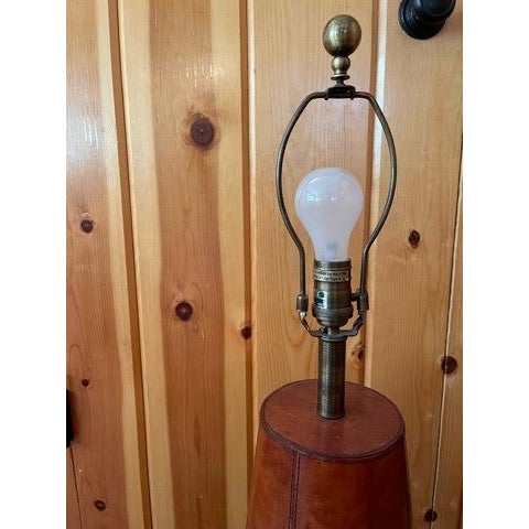 Luxury comes to mind with this leather Bradburn table lamp. Rich mahogany toned leather with intricate detailing and...