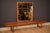 Mid century modern large hanging wall mirror in teak circa 1960's. This decorative accent piece displays natural wood...