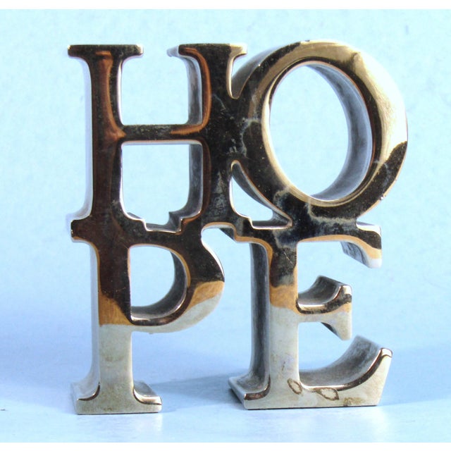 Awesome chrome metal paperweight in the shape of American Pop artist Robert Indiana's "HOPE" sculpture. This high quality...