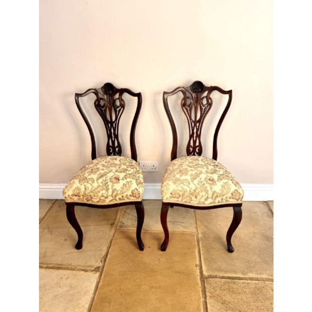 Elegant pair of quality antique Victorian carved mahogany side chairs, having a quality pair of Victorian side chairs with...
