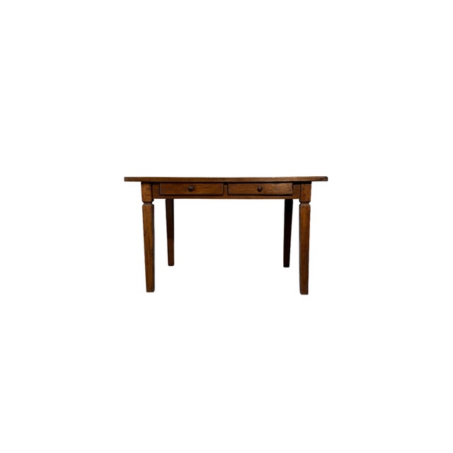 Walnut wood table dating back to the nineteenth century, characterized by an elegant linearity and enriched by a double...