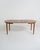 Round teak table with two central extensions and four square legs. Scandinavian production, 1960s. Made in Scandinavia in...
