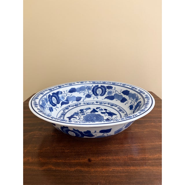 A gorgeous Chinoiserie blue and white porcelain shallow bowl, planter, or decorative charge plate featuring Asian floral...