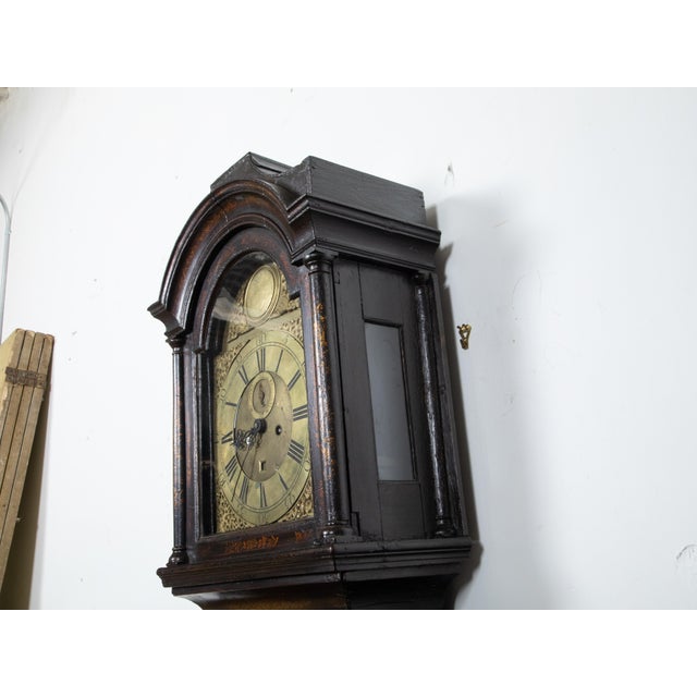 An English George III period tall case clock from the mid 18th century, with chinoiserie décor and brass face by James...