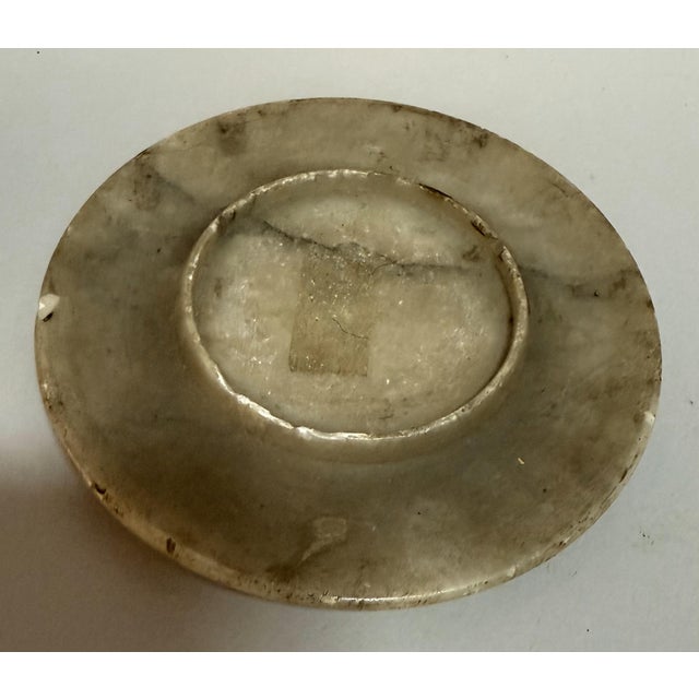 This unique 20th-century sculptural object features a solid, hand-carved stone form with incised ribbing and a softly...