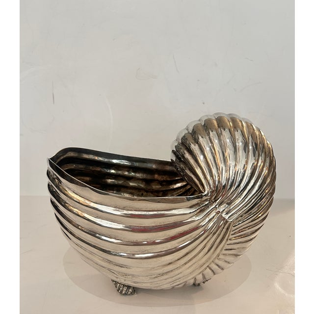 Just in this mid-century Hollywood Regency style centerpiece . It is beautifully cast into a very realistic Nautilus Shell...