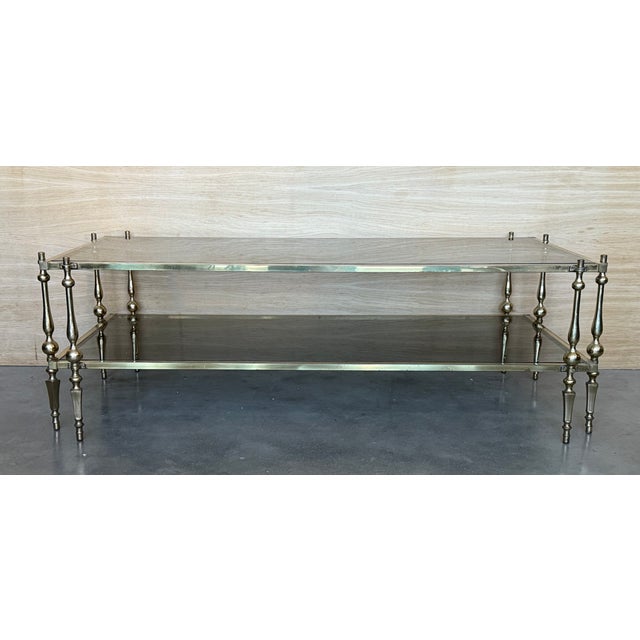 Mid-Century Modern two-tier brass and mirror beveled glass side table in Maison Jansen style with fluted brass legs and foot.