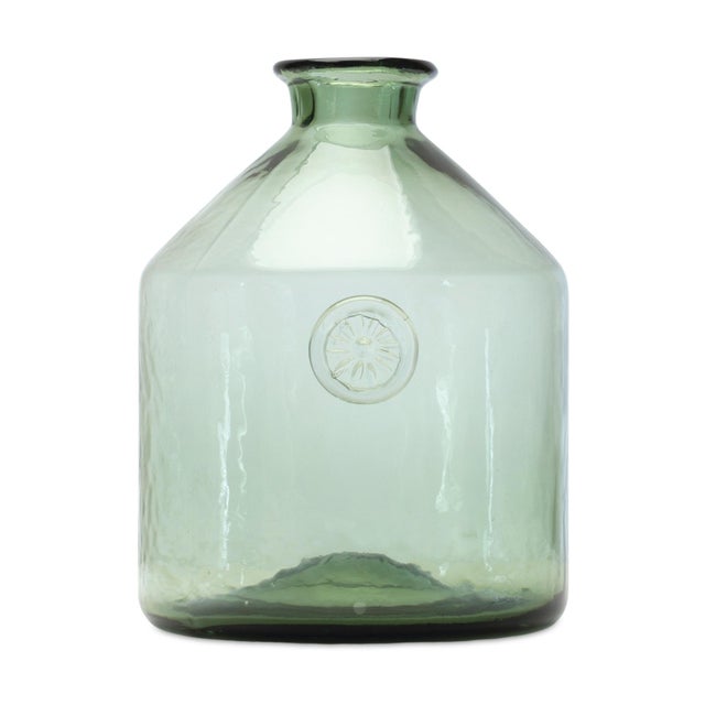 Add a touch of sophistication to your home with the Sage Glass Bottle Neck Vase. This 9-inch tall vase features a modern...