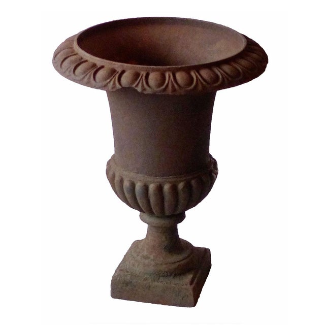 Set of three antique, early 20th century cast iron Campagna form garden urns. Egg and dart motif on the rims and melon...