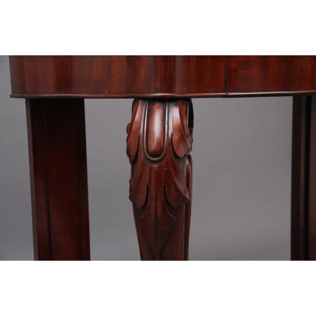 19th Century mahogany and marble top console table, having a shaped and carved back with a decorative moulded edge, the...