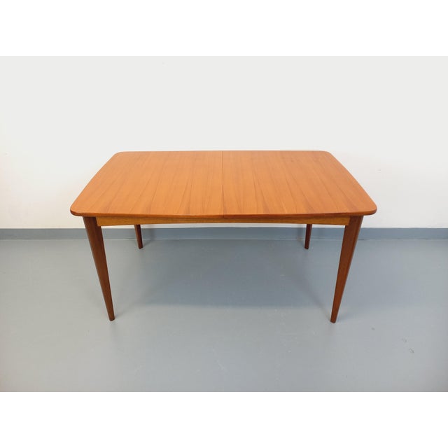 Vintage rectangular dining table in Scandinavian style from the 1950s/60s, made of teak, with a rounded rectangular top...