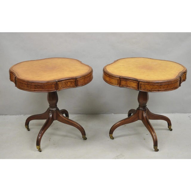 Vintage English Regency Style Leather Top Mahogany Drum End Tables with 4 Drawers Each - a Pair. Tables feature brass...