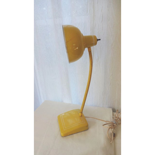 Bright sunny yellow, mid century enameled goose-neck desk lamp with thin white stripe detailing. Original wiring in...