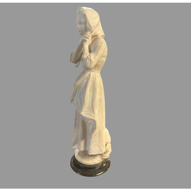 Impressive antique carved alabaster figural sculpture depicting a young woman or maiden in traditional dress, standing...