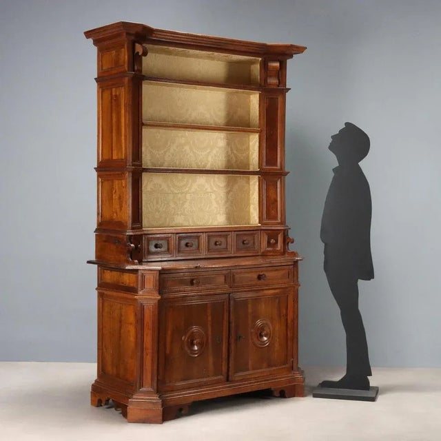 Period walnut bookcase. Base with a pair of doors surmounted by two drawers in the lower section, uprights angled at...