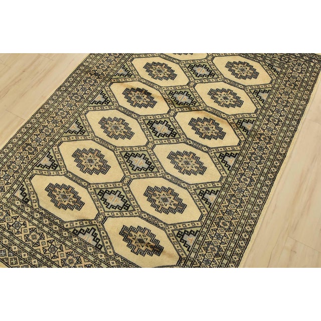 A tribal Bokhara Jaldar rug hand-knotted with an all-wool pile on a cotton foundation. This finely woven oriental rug...