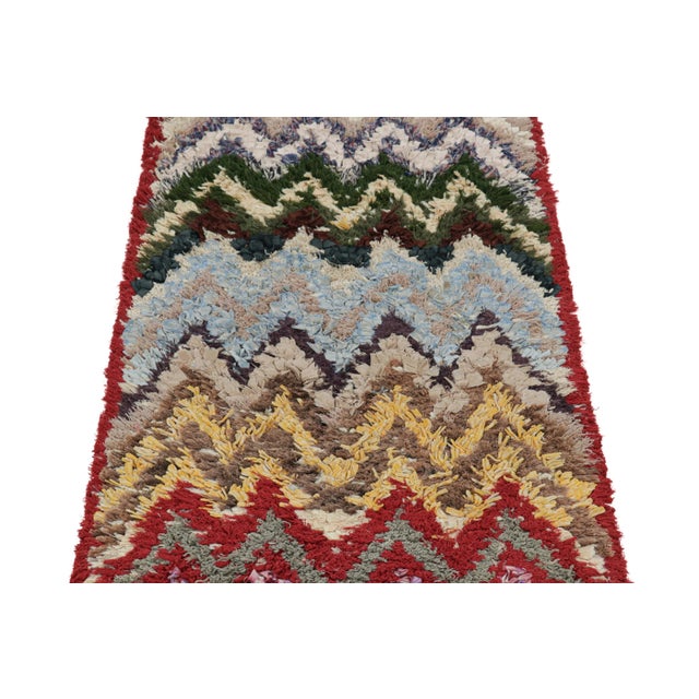 Hand-knotted in wool and originating from Morocco circa 1950-1960, this 3x6 vintage Moroccan rug is an extremely rare...