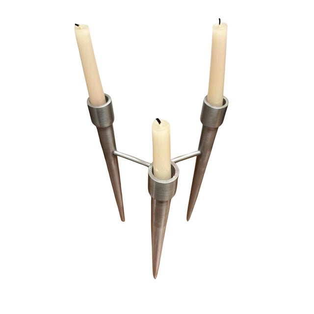 A striking Scandinavian Modern three-light candelabra crafted in brushed aluminum, purchased in Denmark and embodying the...