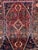 This extraordinary hand-knotted wool area rug showcases a traditional Persian Qashqai tribal style. The dramatic center...