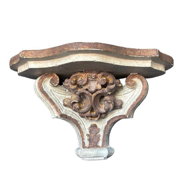 A remarkably decorative pair of large vintage Italian-style wall brackets, combining sculptural Rococo scrollwork with a...
