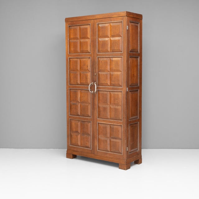 Two door oak cupboard with fielded panelling edged with plated beading. Retractable hanging rails. France circa 1940.