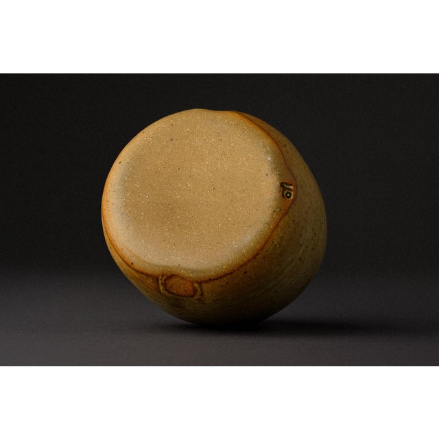 A pinched vessel that recalls a ceremonial jar, complete with subtle spouts and button detail. A rare, intimate work, well...