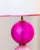Pair of lamps with three Murano glass spheres in matte pink tones. The three spheres rest on a circular brass base with...