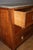 A Directoire period walnut commode, decorated with a diamond pattern of dark wood marquetry, featuring three drawers,...