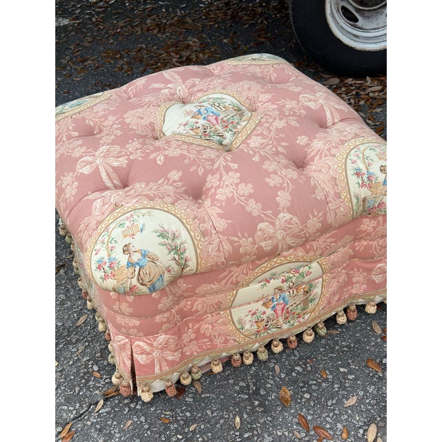 Brief description: Vintage Brunschwig & Fils upholstered ottoman featuring a tufted cushion top and skirted base with...