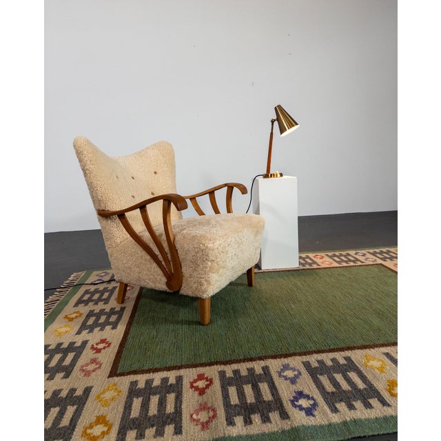 A beautifully patinated brass and teak table lamp from Swedish lighting manufacturer Falkenbergs Belysning, circa 1950s....