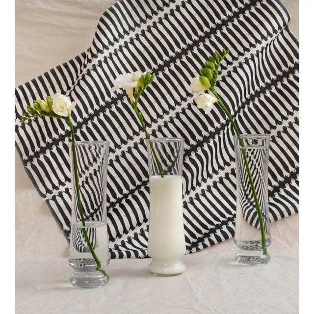 From a distance, this graphic fabric has an appealing rhythmic energy. Move closer, and connected black and white hands...