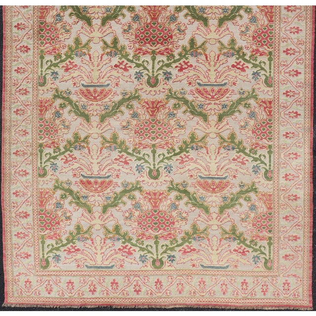 Measures: 6'5 x 12'0 Antique Spanish Gallery Rug with Coral, Olive, and Cream Floral Design. Keivan Woven Arts /...