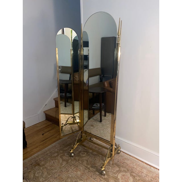 Striking large functional 3 way floor mirror on casters having eye catching finials and elegant details along its base and...