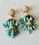 Dramatic mid-century chandelier earrings featuring cascading robin’s-egg-blue faux turquoise teardrop beads, creamy faux...