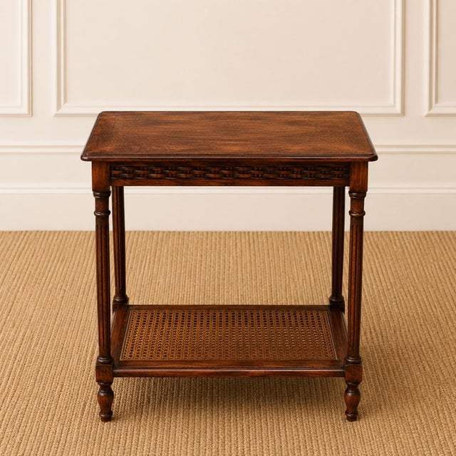 This elegant 19th Century English oak two-tier side table showcases the timeless craftsmanship and refined proportions...