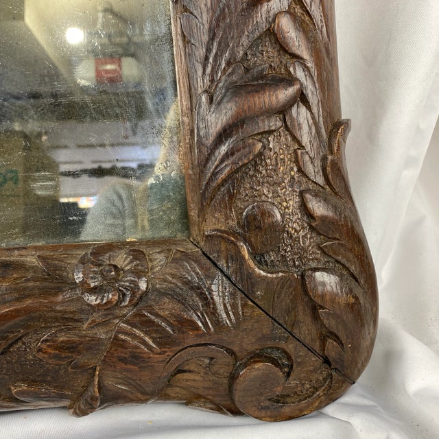 English 18th c. deeply carved mirror. Original mirror with foxing.