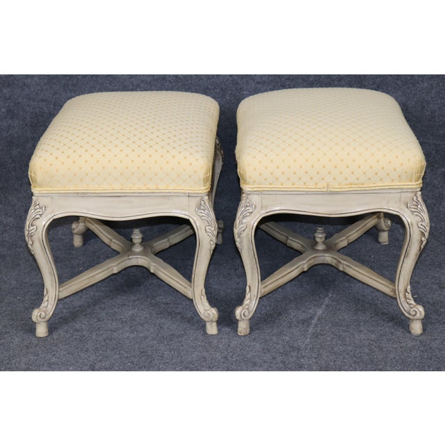 A charming and beautifully proportioned pair of French Louis XV-style upholstered stools, dating to the 1950s or 1960s....