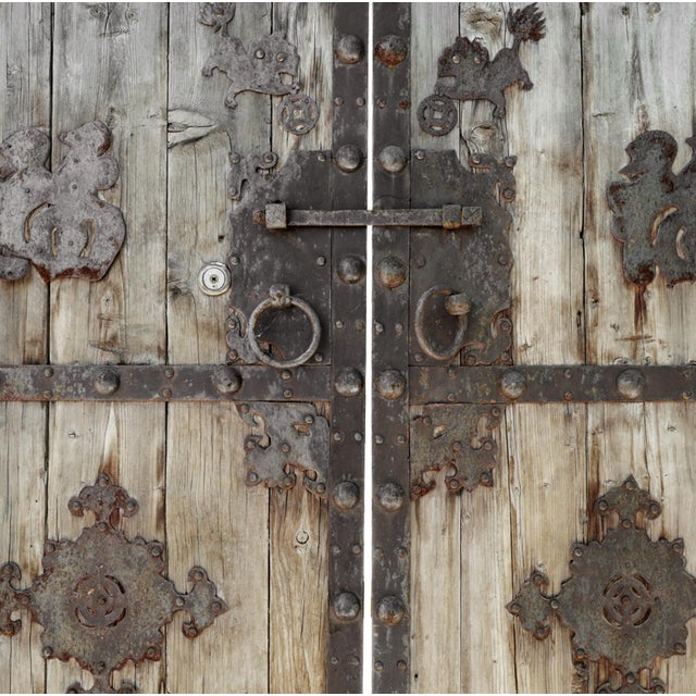 Antique Mongolian solid wood door with original iron decorative details, straps, and ring handles. Beautiful aged finish....