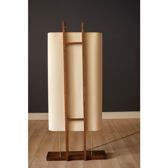 Vintage sculptural floor lamp in walnut circa 1960's. This unique art piece displays all the elements featuring a...
