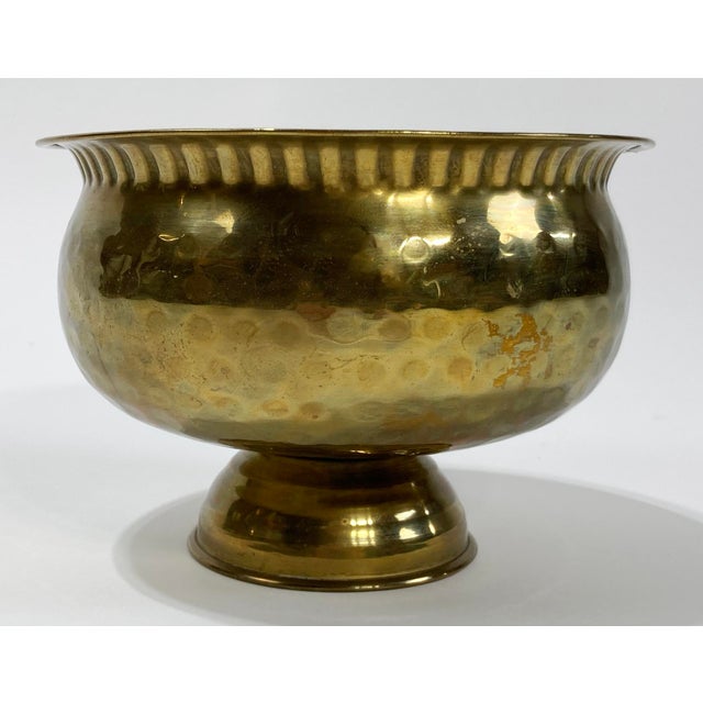 Vintage round hammered brass decorative bowl featuring pie shell crimp rim and pedestal base. Lovely patina.