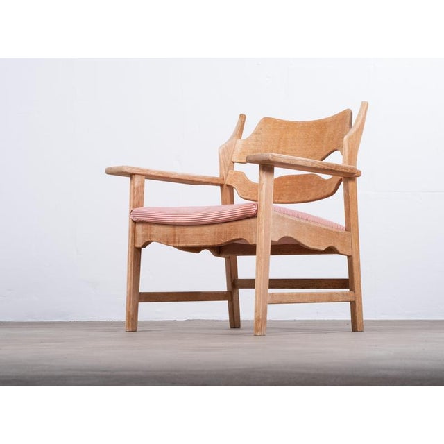 Danish lounge chair designed by Henning Kjærnulf and produced by Nyrup Møbelfabrik in the 1960s. Crafted in solid oak, the...