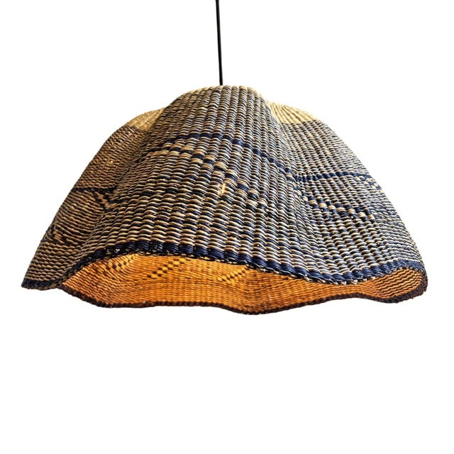 Hand dyed navy and natural hand woven grass basket lamp. Unique and striking piece with hand woven patterns and vibrant...