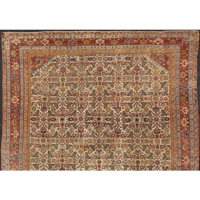Measures:10'9 x 13'8 Antique Persian Ferahan rug with all-over Herati design in ivory, coral, green, antique Sultanabad...