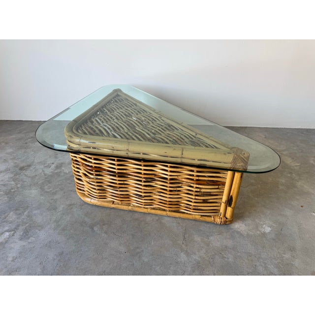 This vintage coastal rattan coffee table brings a breezy, tropical aesthetic to any living space. Featuring a unique...